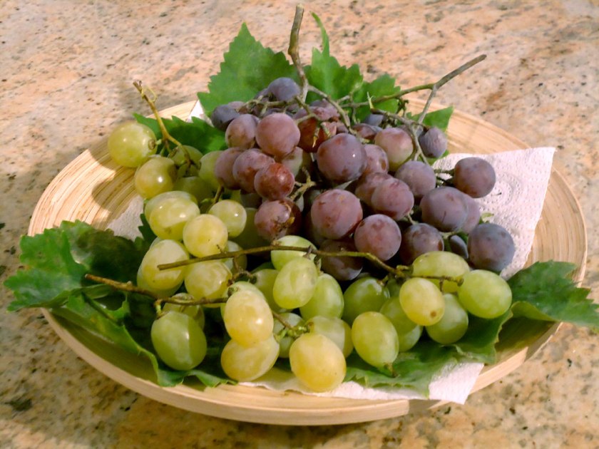 black and white grapes on a dish