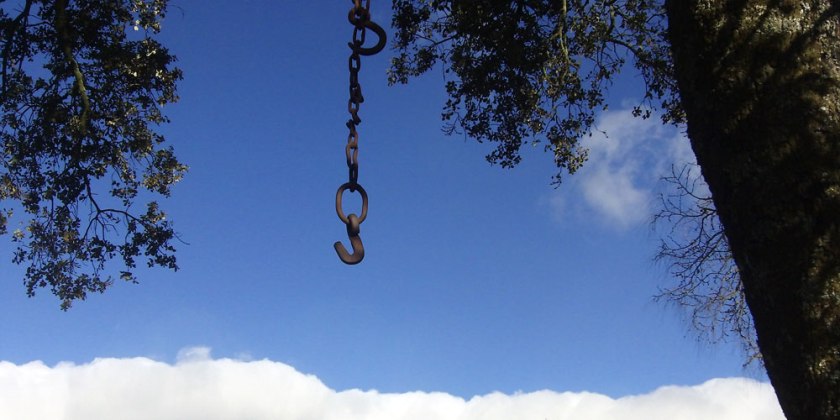 hook & chain silhouette against sky