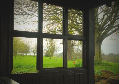 multi-frame bus-stop window looking out onto fields