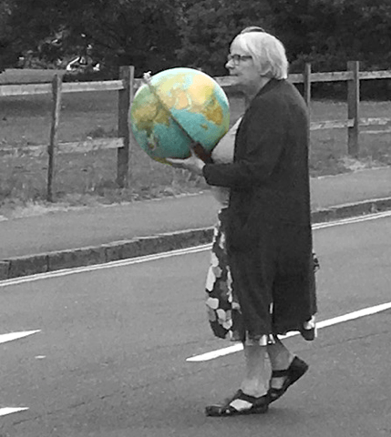 Elderly woman carrying a globe
