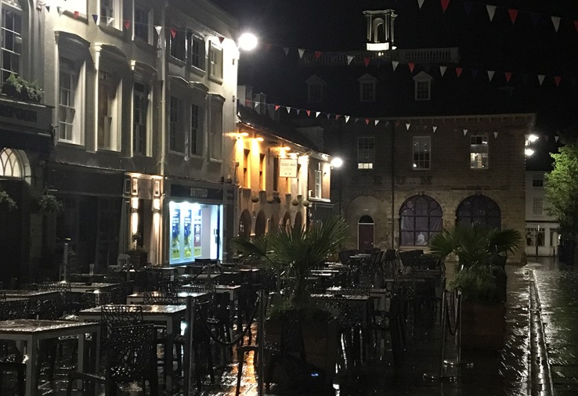 pub tables & chairs; market square; wet night