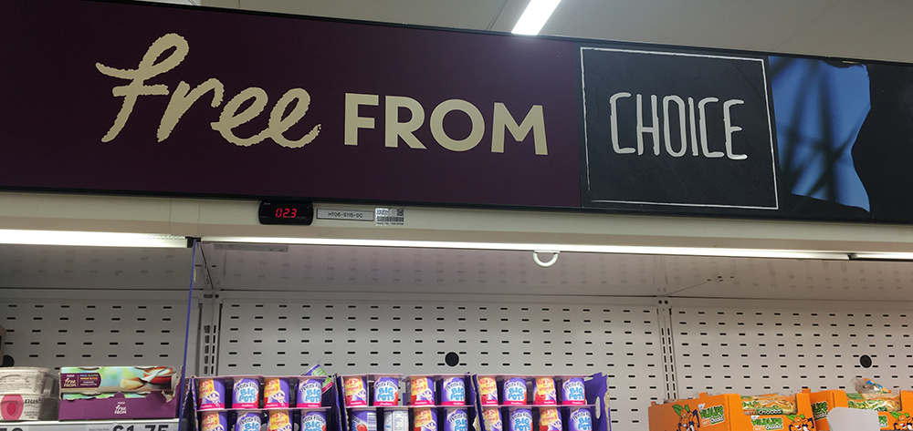 Supermarket shelf advertising "Free from: Choice"