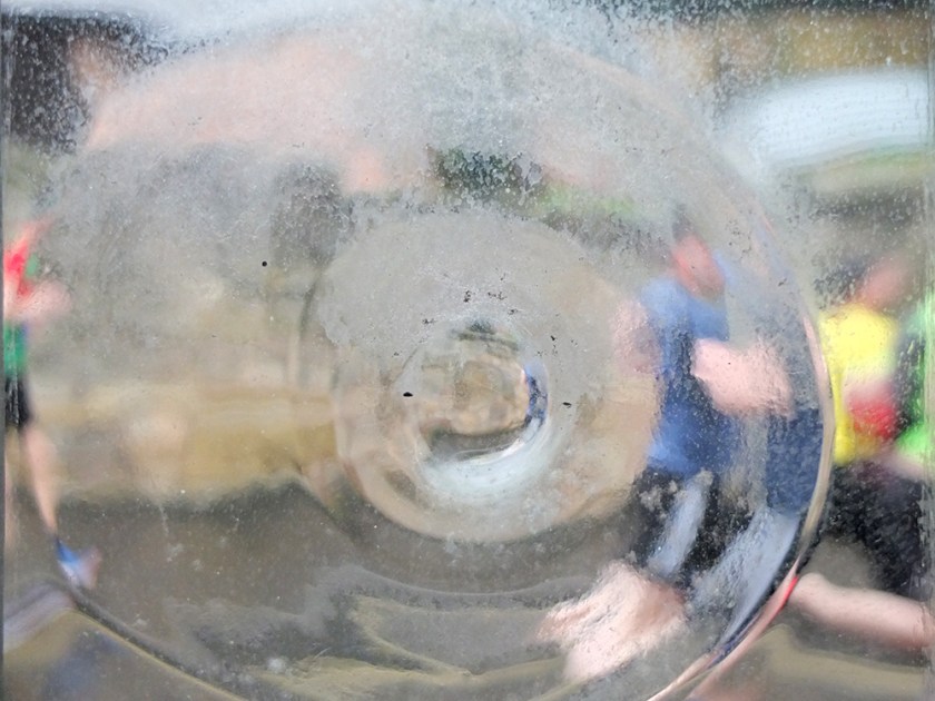 marathon runners seen through distorting window