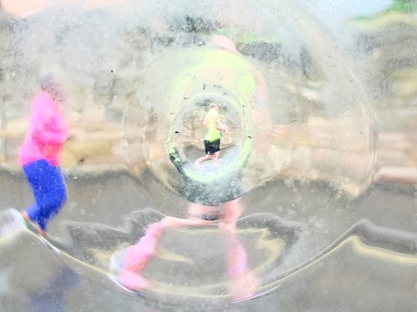 marathon runners seen through distorting window