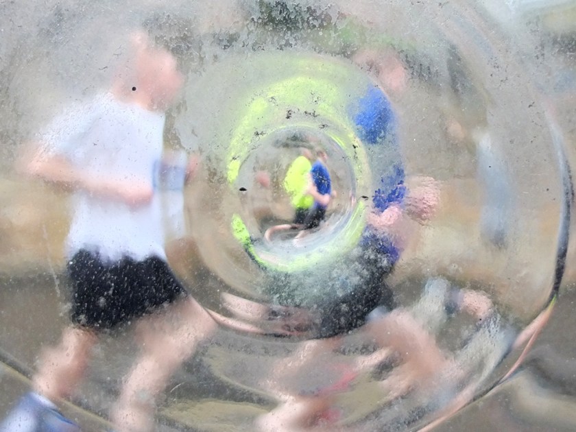 marathon runners seen through distorting window
