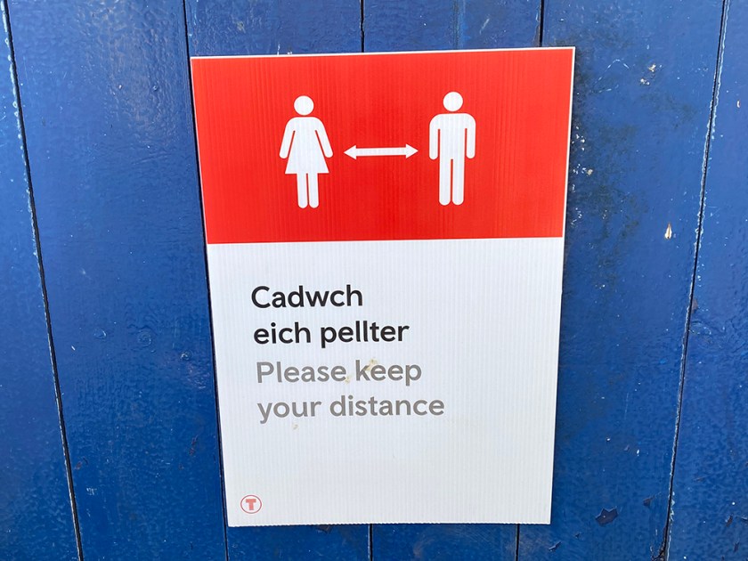 social distance poster Welsh and English