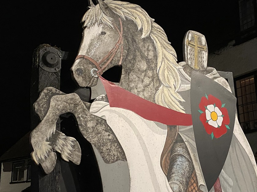 knight in armour on horse painted sign